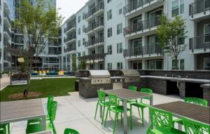 an outdoor patio with tables and chairs and a grill at Buckhead Luxe in Atlanta