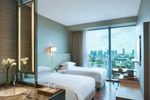 una camera d'albergo con due letti e una grande finestra di Courtyard by Marriott Singapore Novena a Singapore