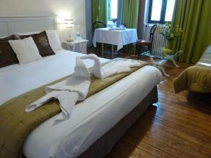 a bedroom with a bed with a towel on it at Domaine Le Village in Villenouvelle +63 photos