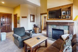 un salon avec un canapé et une cheminée dans l'établissement Springs Lodge 8906, à Keystone