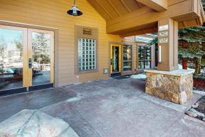 a home with a patio with a stone fireplace at Springs Lodge 8906 in Keystone