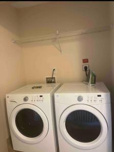 a laundry room with a washer and a dryer at Heart of Atlanta in Atlanta