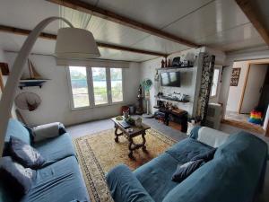 a living room with a blue couch and a table at Beach Wave Melides Villa in Melides