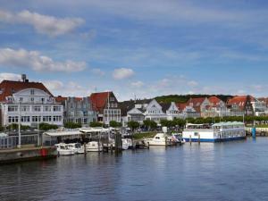 a group of boats docked in a harbor with houses at Apartment in Lübeck-Travemünde in Rönnau