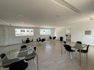 an empty room with tables and chairs in it at Apto praia ponta de campina in Cabedelo