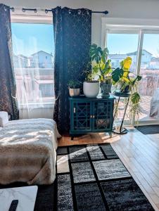 a room with a table with potted plants on it at The Love Love Stay in Edmonton