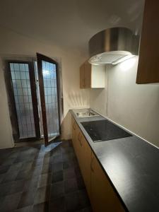 a kitchen with a sink and a counter top at Crete home in Oldham