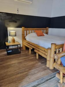 a bedroom with a bed and a table with a lamp at Casa Bajo Congo in Cacique