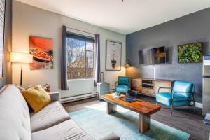 a living room with a couch and a table at Oxford Apartment by At Mine Hospitality in Seattle