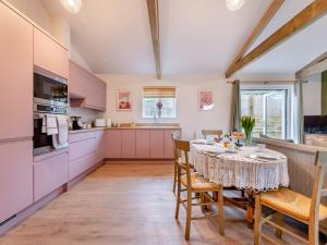 a kitchen and dining room with a table and chairs at Swallow Barn in Bigbury on Sea