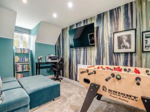 a bedroom with a bed and a pool table at Dukes House in Corsham