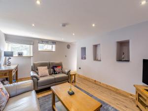 a living room with a couch and a table at Cowcroft - Uk45063 in Tideswell