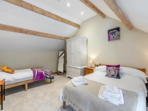 sypialnia na poddaszu z 2 łóżkami i biurkiem w obiekcie Cowcroft - Uk45063 w mieście Tideswell