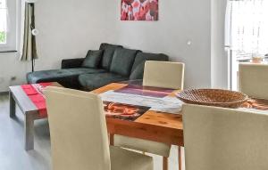 a living room with a table and a couch at Amazing Home In Mirow Ot Qualzow With Wifi in Qualzow