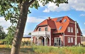 a large red house with an orange roof at Nice Apartment In Userin Ot Gro Quassow With Wifi in Groß Quassow