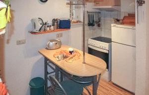 a small kitchen with a small table in a room at 1 Bedroom Awesome Apartment In Neppermin-usedom in Neppermin