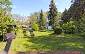 a park with two chairs and a picnic table in the grass at 1 Bedroom Stunning Home In Jabel Ot Loppin in Loppin