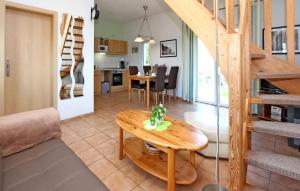 a living room and dining room with a wooden table at 1 Bedroom Stunning Home In Jabel Ot Loppin in Loppin
