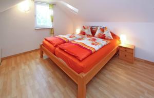 a bedroom with a large bed with an orange comforter at 1 Bedroom Stunning Home In Jabel Ot Loppin in Loppin