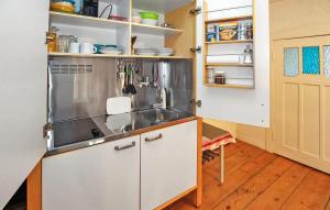 a kitchen with a sink and a counter top at Cozy Apartment In Kieve With Wifi in Kieve