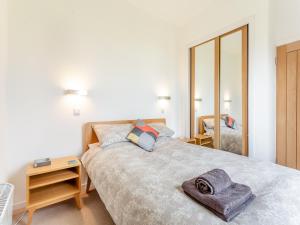 a bedroom with a large bed and a mirror at Airor in Kilmore