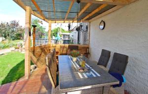 a patio with a table and chairs on a deck at Beautiful Apartment In Meesiger With Kitchen in Meesiger
