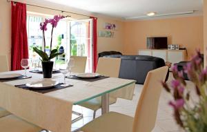 un comedor con una mesa con vasos y flores. en Amazing Home In Verchen With Kitchen, en Verchen