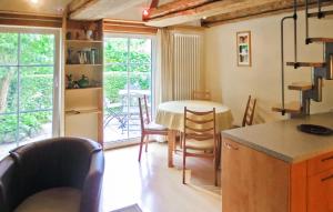 a kitchen and dining room with a table and chairs at Beautiful Home In Grnow With Wifi in Grünow