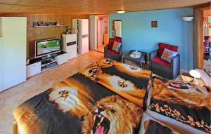 a large bed in a living room with a tiger blanket at 1 Bedroom Stunning Home In Waren mritz in Kölpinsee