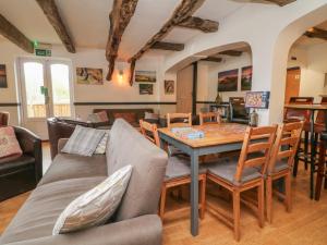 a living room with a table and chairs at Chalet Log Cabin C11 in Ilfracombe