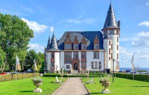 a large castle with turrets on top of a green field at 1 Bedroom Stunning Home In Klink in Klink