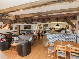 a living room with a couch and a bar at Chalet Log Cabin C9 in Ilfracombe