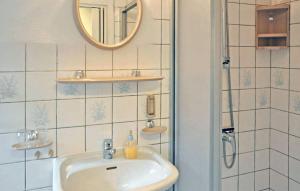 a bathroom with a sink and a mirror at Beautiful Apartment In Neustrelitz With Kitchen in Neustrelitz
