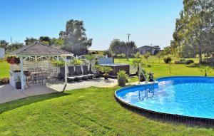 a swimming pool in a yard with a gazebo at Beautiful Apartment In Neppermin-usedom With Wifi in Neppermin