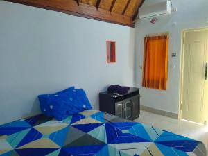 a bedroom with a bed and a window and a door at Putri Nyale Bungalows & Rooms in Kuta Lombok