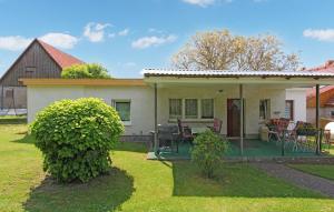 a small white house with a patio and a yard at 2 Bedroom Cozy Home In Blankensee Ot Gro Sch in Blankensee