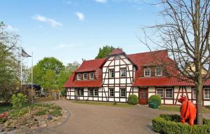 a red and white house with a red roof at 2 Bedroom Cozy Apartment In Sdmritz in Vipperow