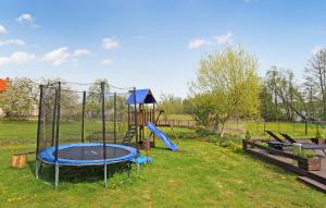 a playground with a slide in a field at 2 Bedroom Cozy Apartment In Sdmritz in Vipperow