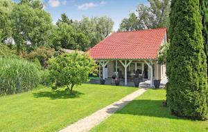 a house with a red roof and a green yard at Beautiful Home In Klink With Wifi in Klink