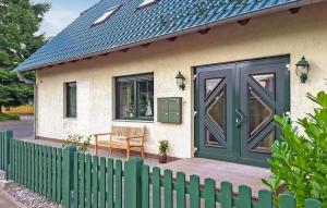 a small house with a green door and a chair at Awesome Apartment In Ueckermnde seebad With Wifi in Neuendorf