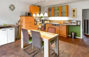 a kitchen with a wooden table and chairs at 2 Bedroom Nice Apartment In Neuendorf in Neuendorf