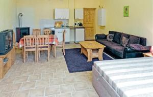 a living room with a couch and a table at Pet Friendly Apartment In Boitzenburger Land Ot With Kitchen in Rosenow