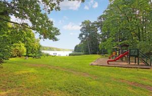 a playground in a park next to a lake at Pet Friendly Apartment In Boitzenburger Land Ot With Kitchen in Rosenow