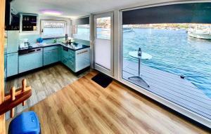 a large kitchen with a view of the water at 3 Bedroom Lovely Ship In Waren mritz in Waren