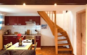 a kitchen with a staircase leading up to a loft at 1 Bedroom Nice Home In Pruchten in Pruchten
