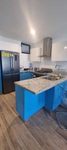 a kitchen with a blue island in a kitchen at SantoriniRD in Punta Cana