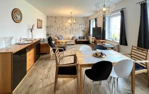 a kitchen and living room with a table and chairs at Beautiful Apartment In Eldetal Ot Wredenhagen With Wifi in Wredenhagen