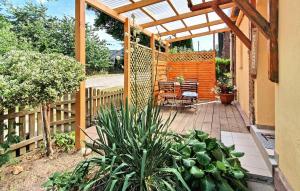 a patio with a wooden pergola and a table and bench at 2 Bedroom Nice Apartment In Grabowhfe Ot Sophienh 