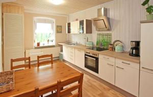 eine Küche mit einem Holztisch und einem Esszimmer in der Unterkunft 2 Bedroom Nice Apartment In Grabowhfe Ot Sophienh 