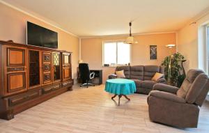 a living room with two couches and a flat screen tv at Nice Home In Grnow Ot Ollendorf With Kitchen in Blankensee